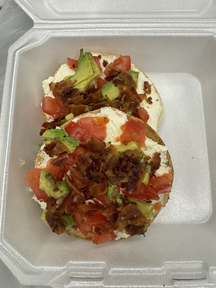 Specialty bagel with cream cheese, bacon and avocado
