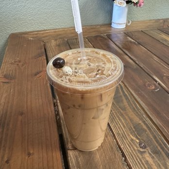 Iced latte on a warm wood table